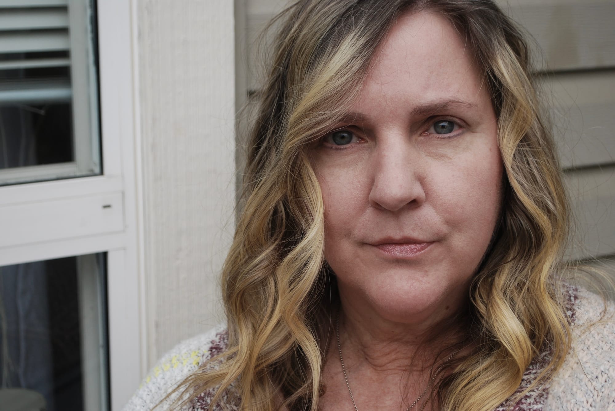 Kir Anvik, 54, stands in front of her Victoria townhouse.