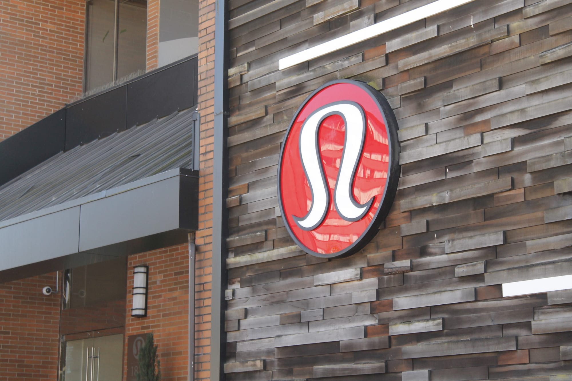 Lululemon's red and white logo is shown on a building in Vancouver.