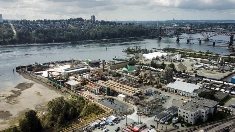 A chlorine plant is shown in North Vancouver beside a harbour.