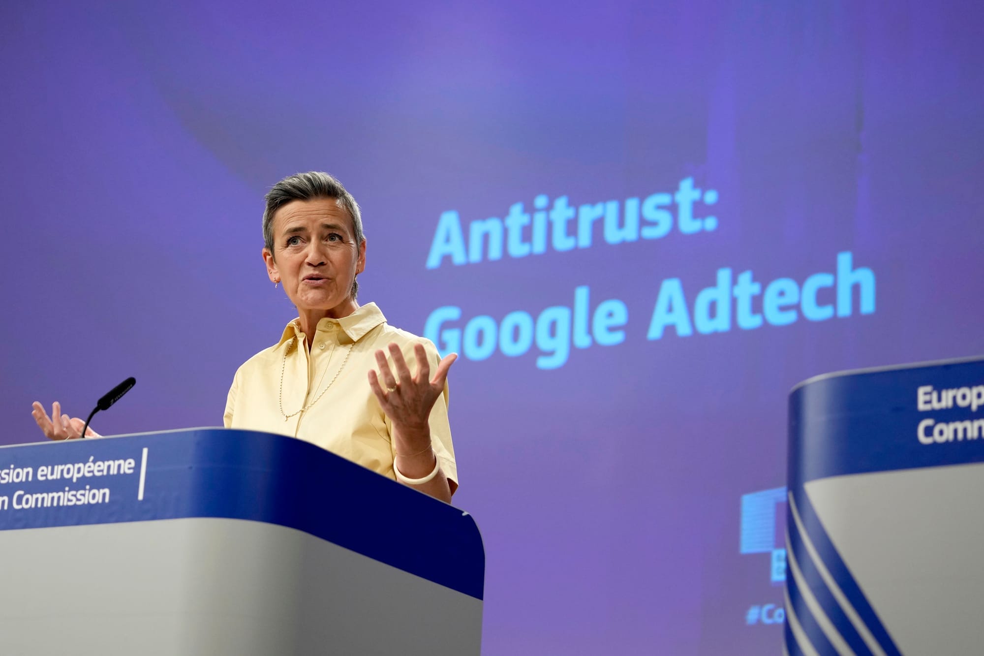 A person stands and speak at a podium against a backdrop that reads Antitrust: Google Adtech