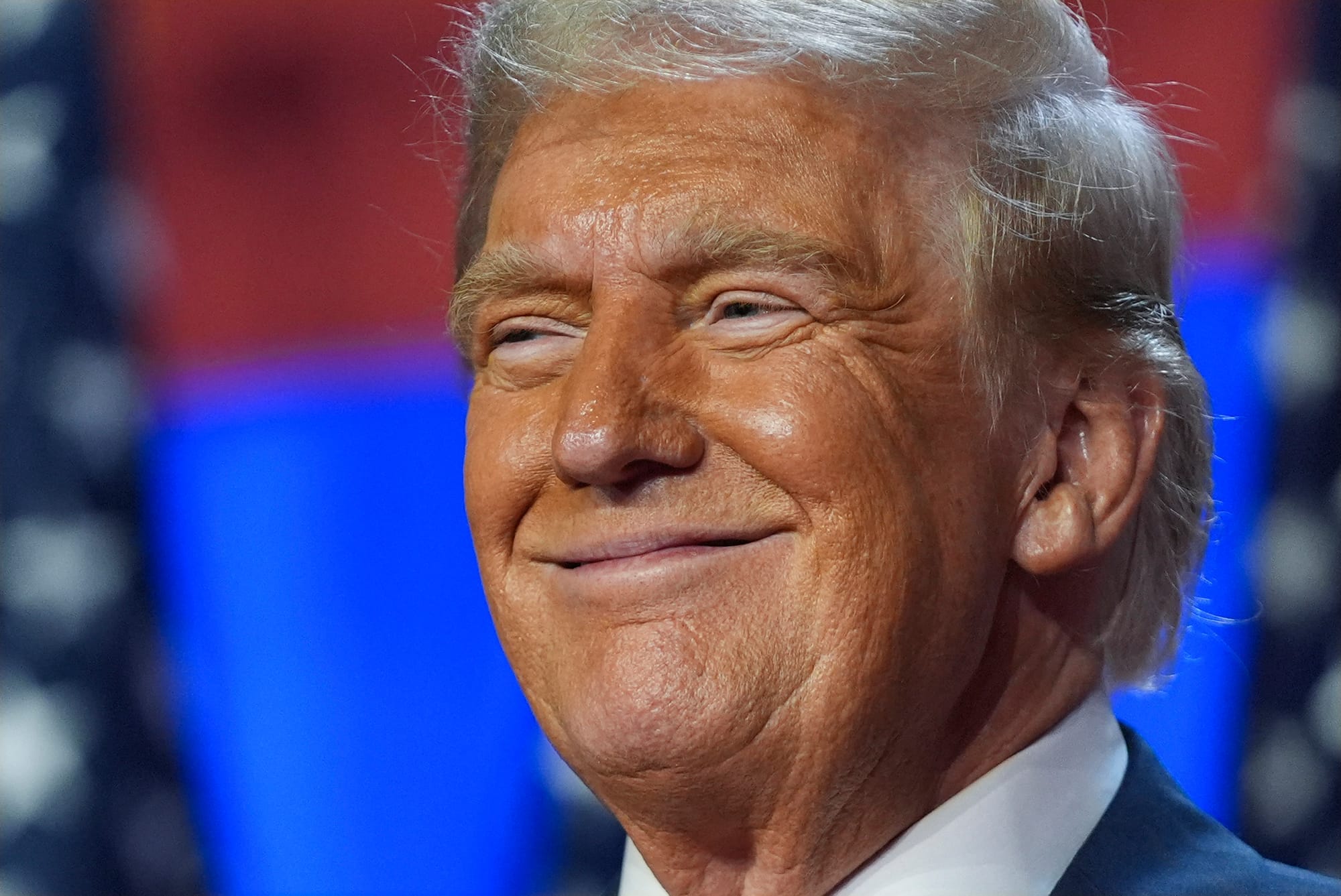 Donald Trump smiles in a close up photo. 