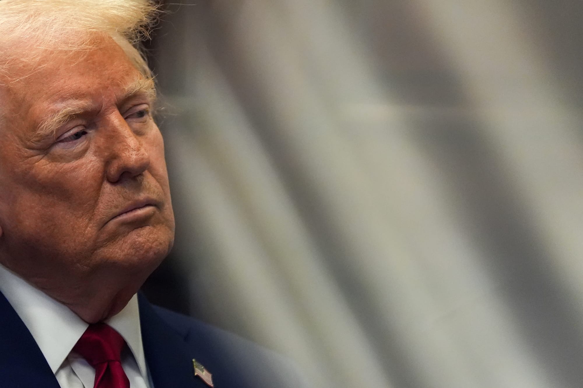 President Donald Trump looks to his side during a news conference.