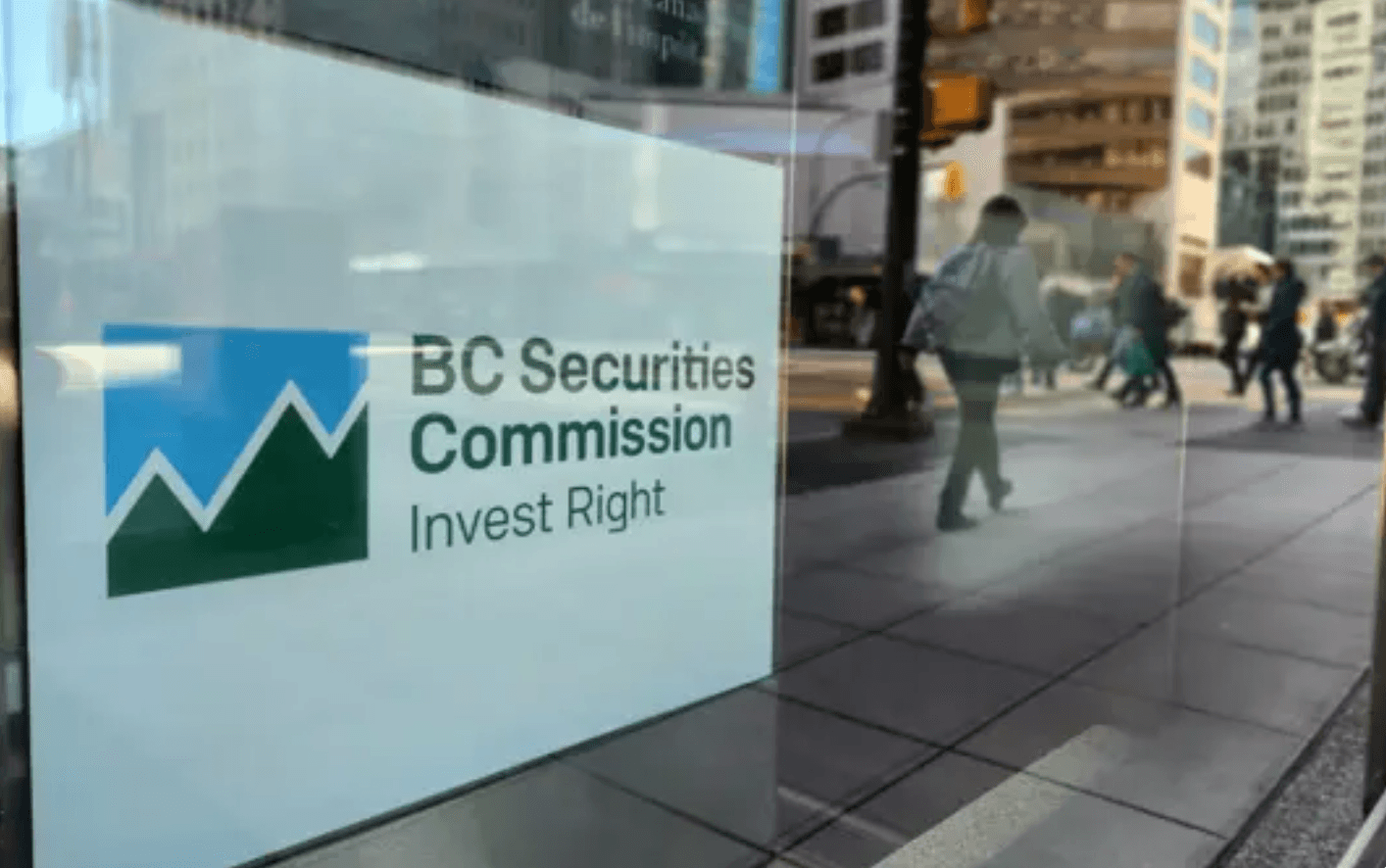 The words "B.C. Securities Commission: Invest Right" are pictured on the side of a glass building in downtown Vancouver