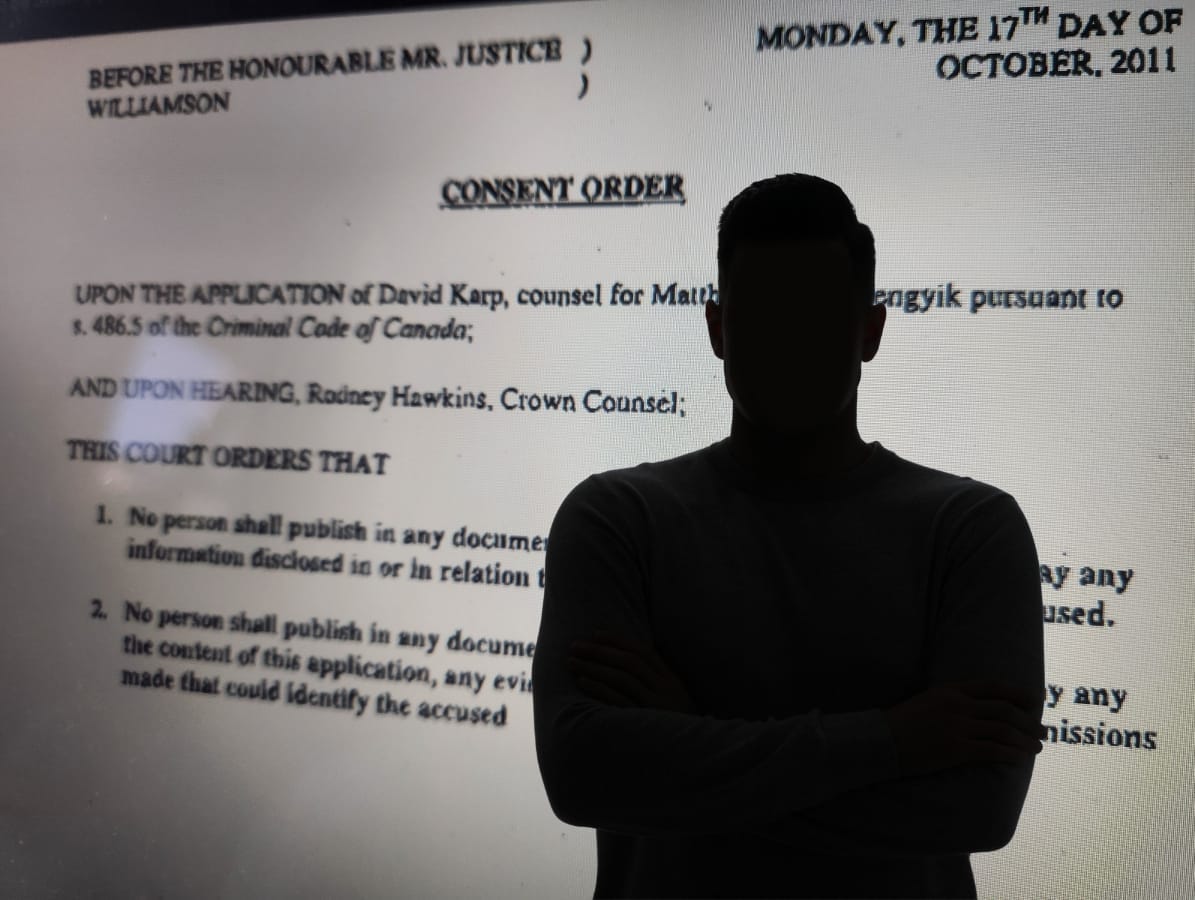 A man is shown in silhouette from the waist up, in front of a written order for a publication ban.