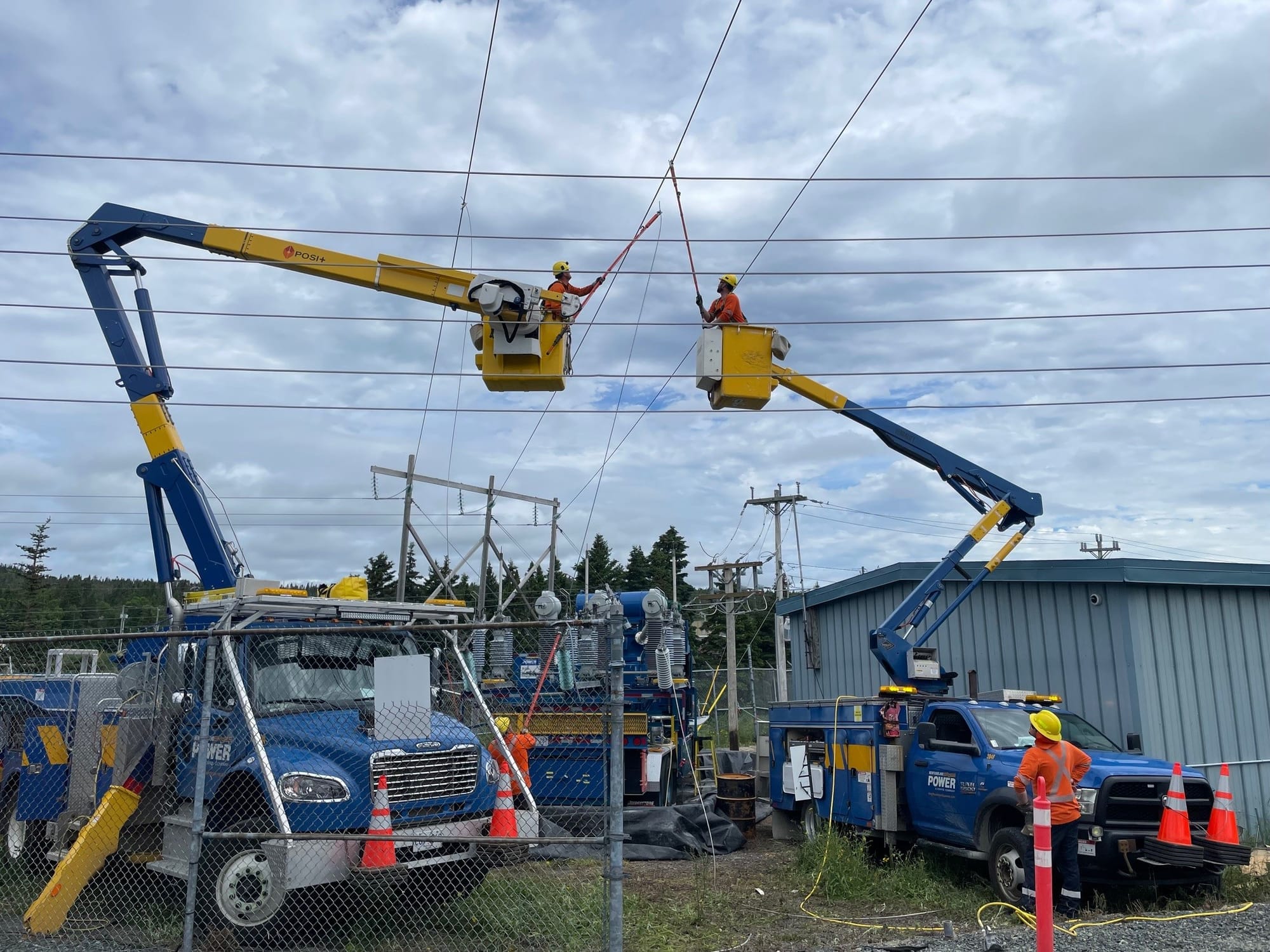Newfoundland Power employees work on powerlines