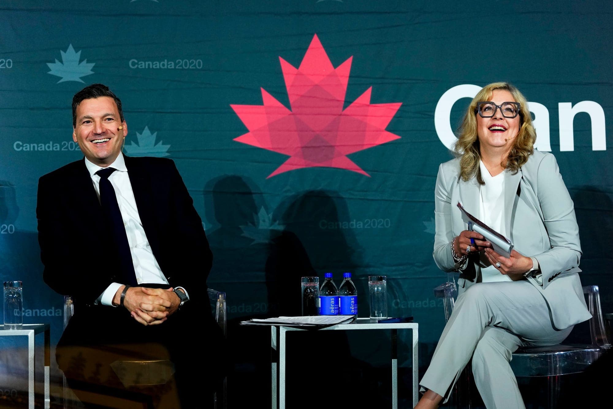 Evan Solomon and Susan Smith sit on stage for a Q&A at a Canada 2020 event in June.