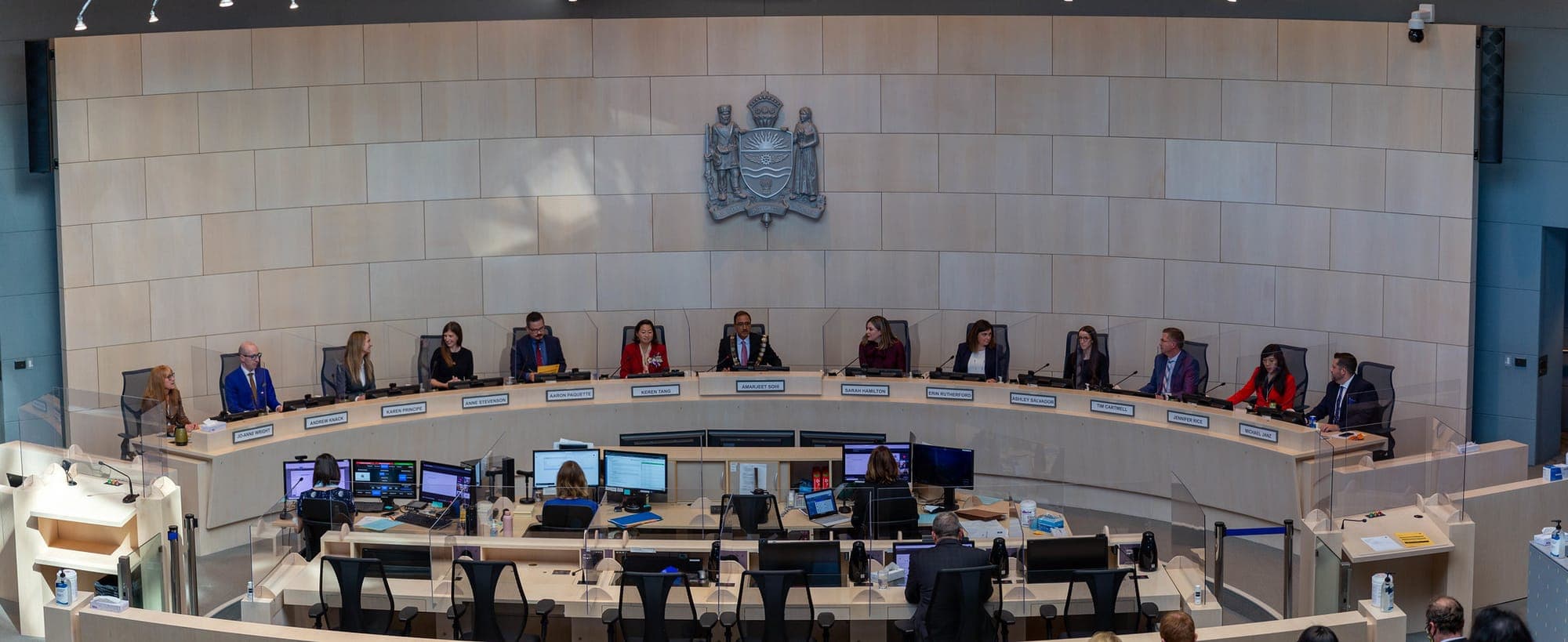 People sitting in the Edmonton city council chambers.