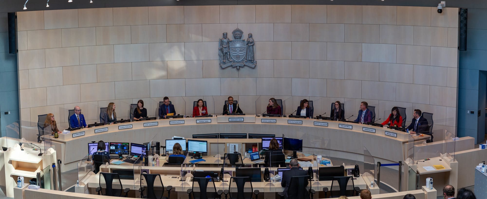 People sitting in the Edmonton city council chambers.