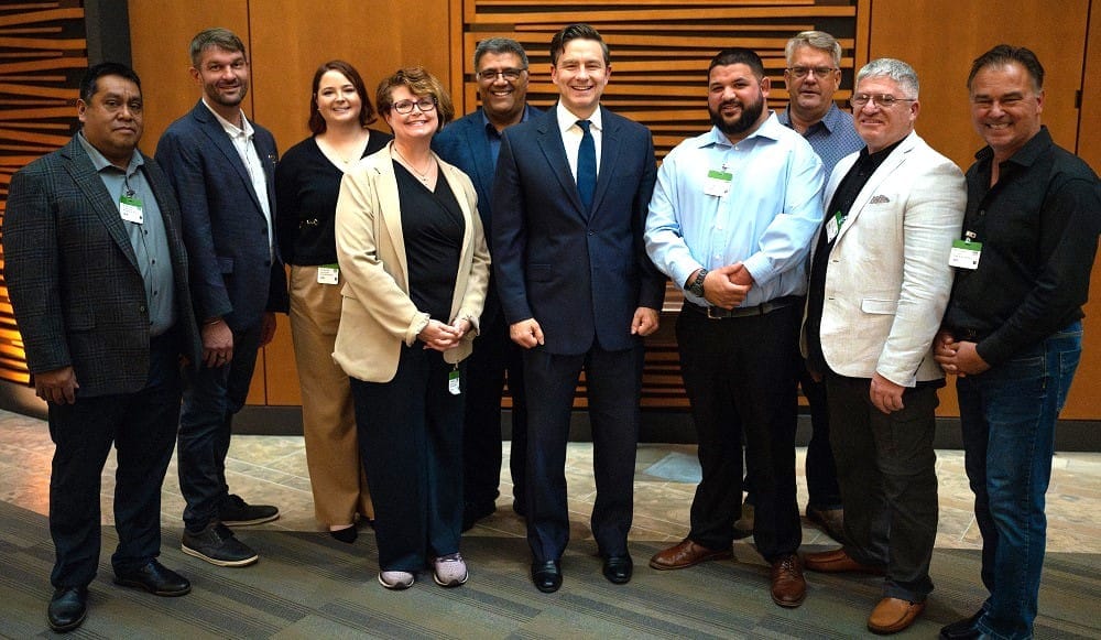 Representatives of the Canadian Mushroom Growers' Association pose for a photo with Conservative Leader Pierre Poilievre in 2024.