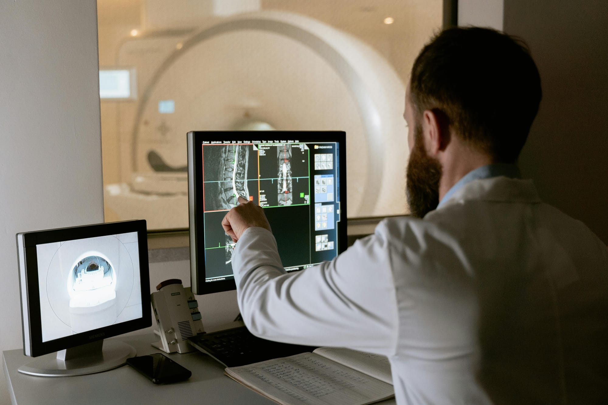 A technician looks at a computer screen during a patient's MRI scan.