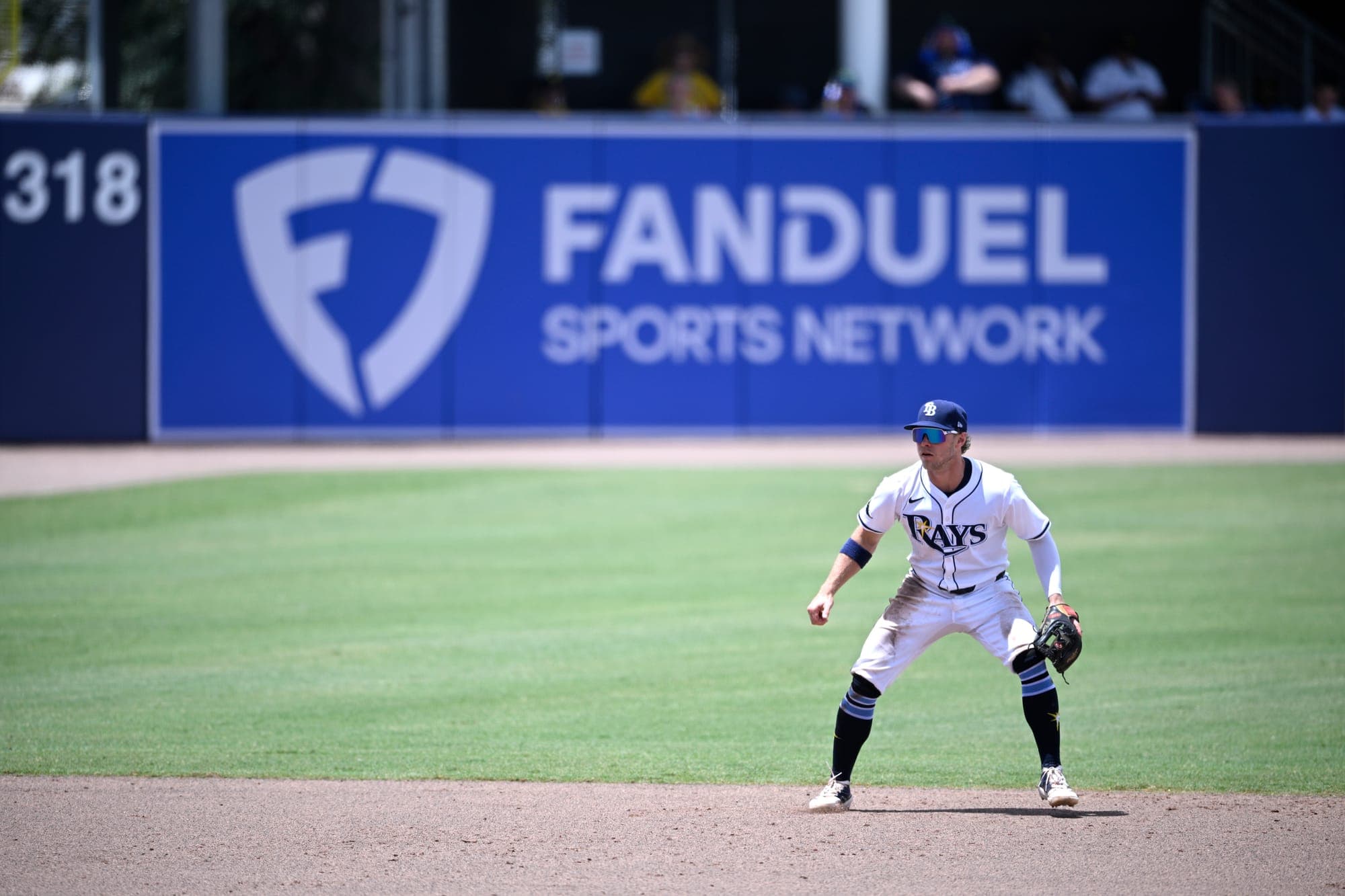 Tampa Bay Rays shortstop Taylor Walls follows a play as a FanDuel Sports Network ad is viewed in the background during a baseball game in June in Tampa, Fla.