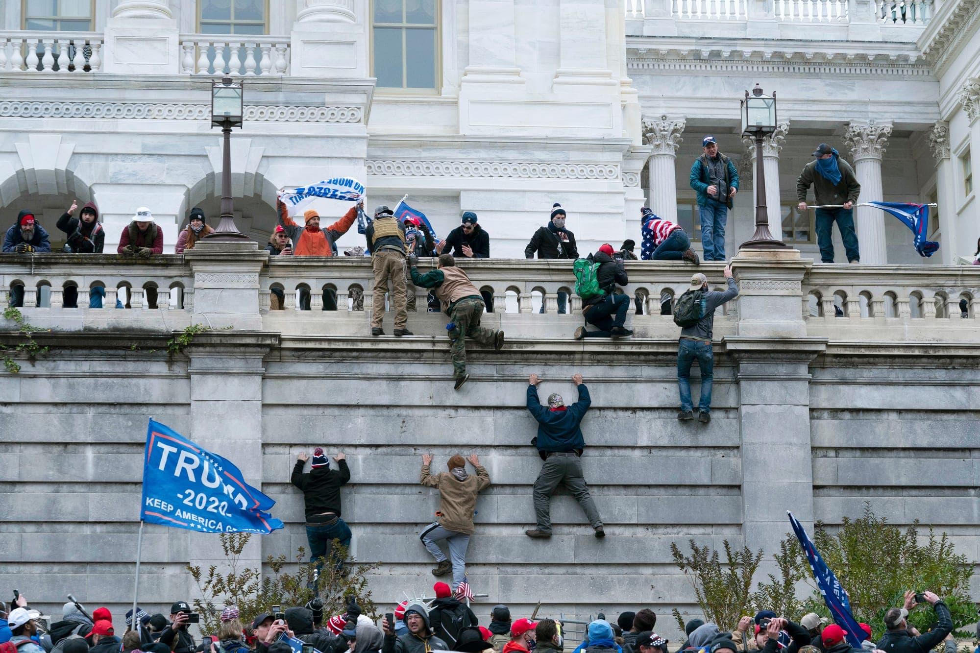 People scale the west wall of the the U.S. Capitol in Washington on Jan. 6, 2021.