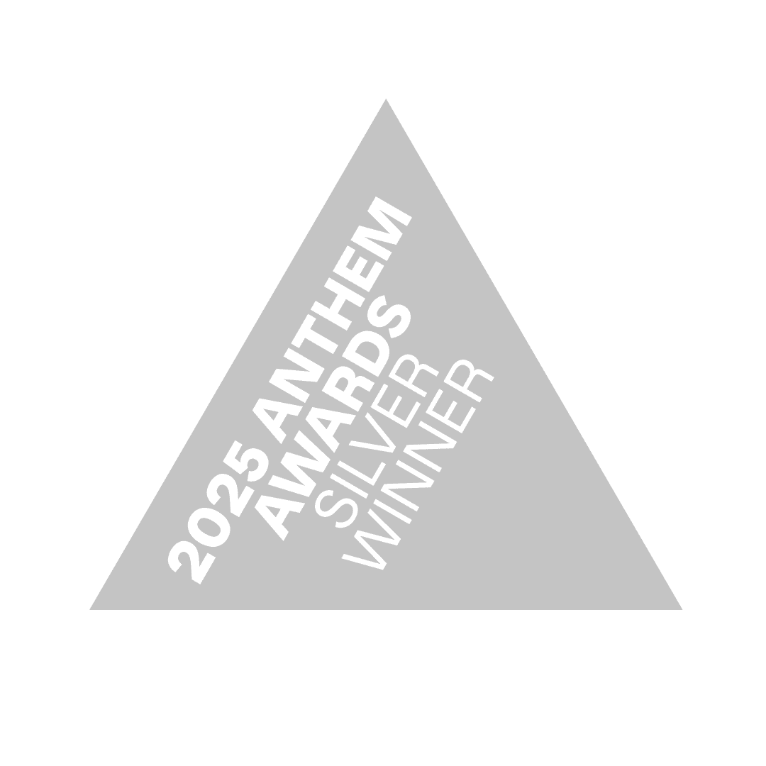 A grey triangle with white writing inside reading: 2025 Anthem Awards Silver Winner."