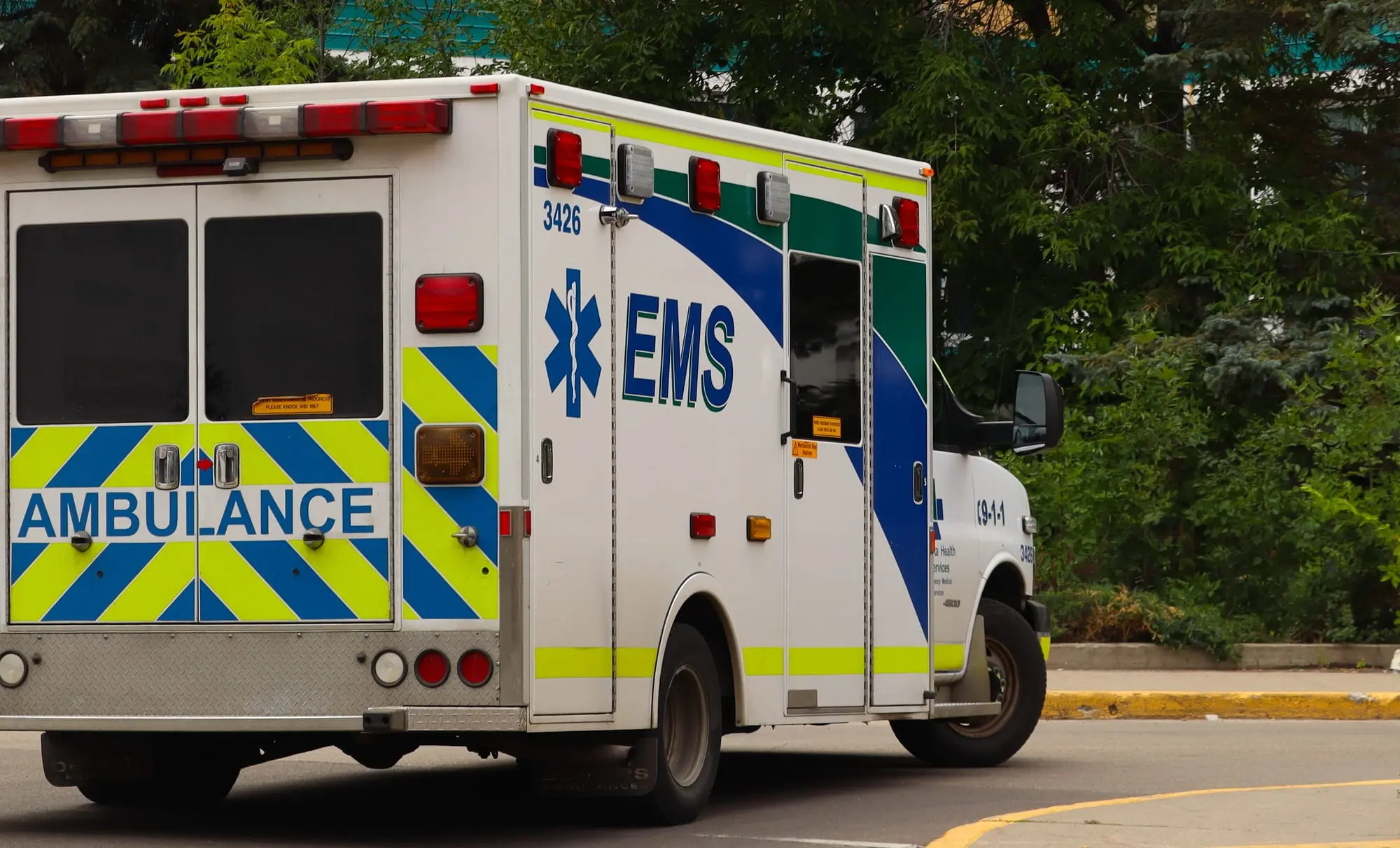 Image of an ambulance with EMS marking seen from behind.