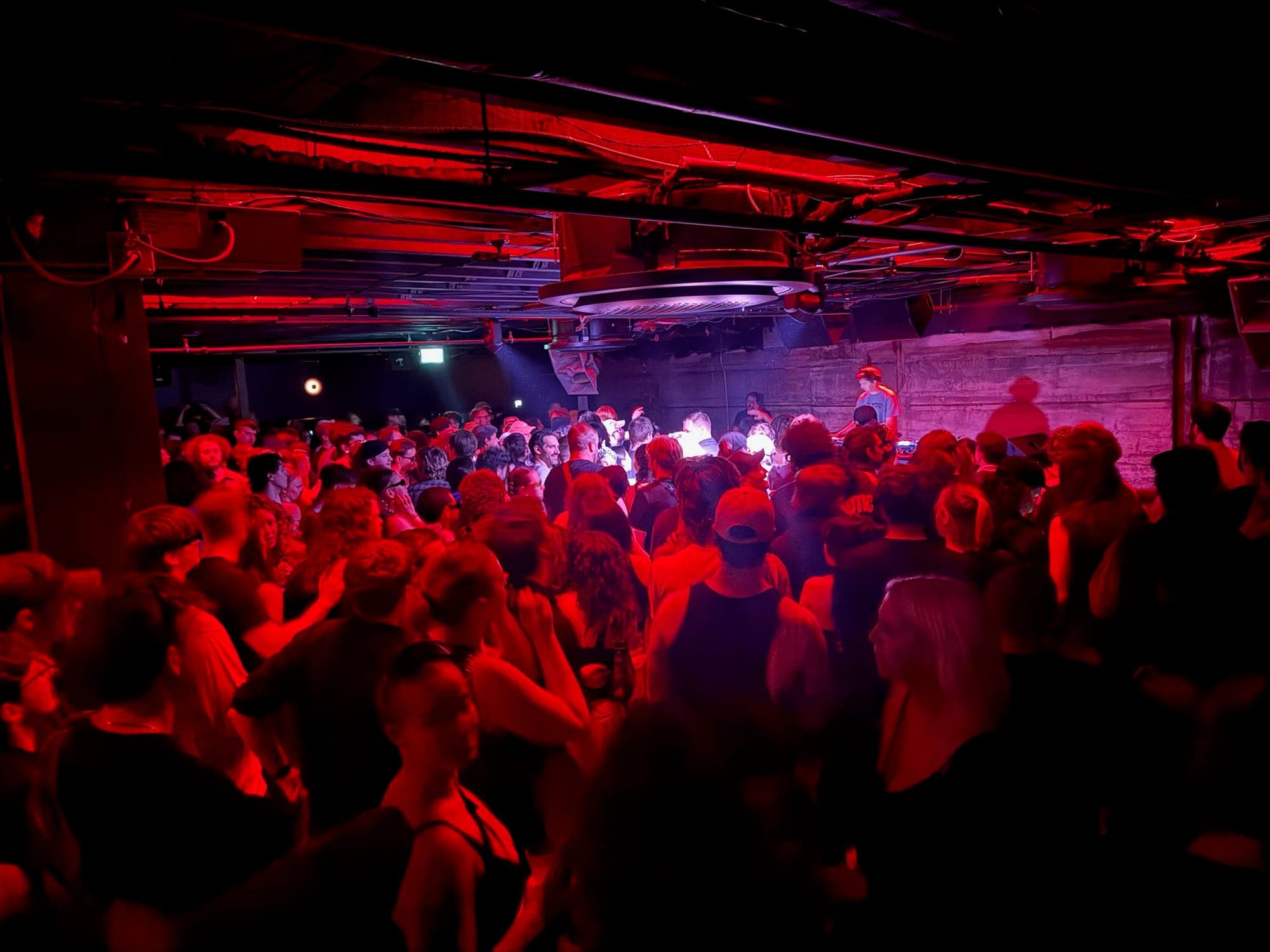 A crowd dances in a nightclub.
