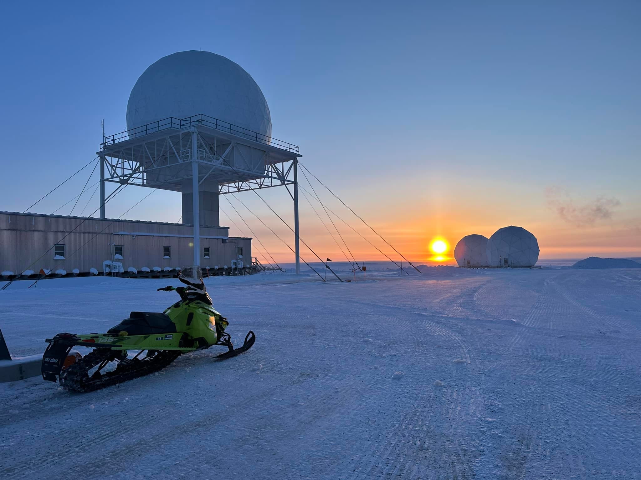 A snowmobile is seen next to the Cambridge Bay Dew Radar Station in Nunavut.