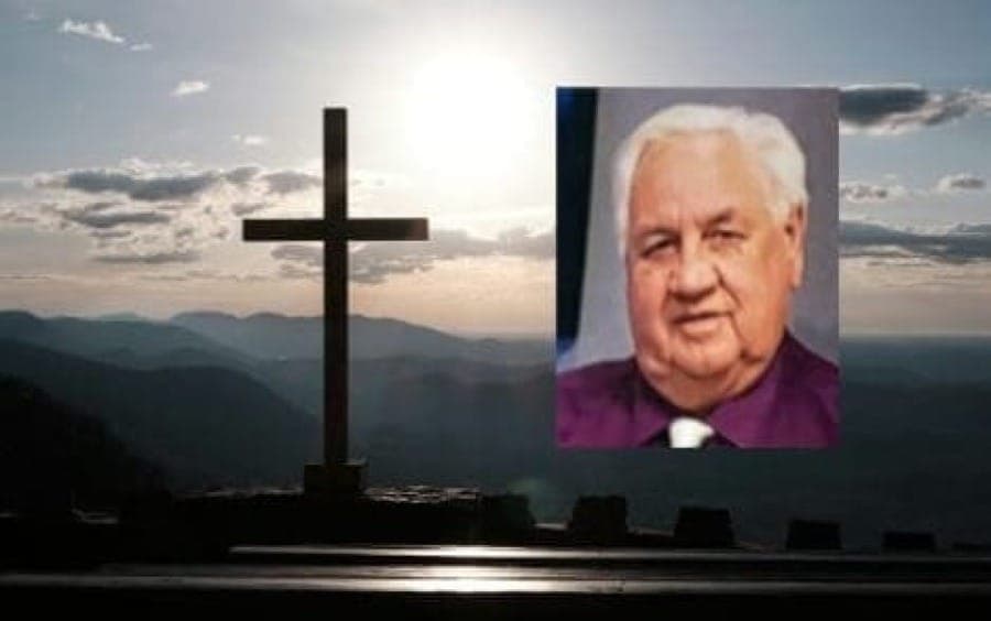 A photo of Pastor Lawrence Trafford is shown against the background of a cros