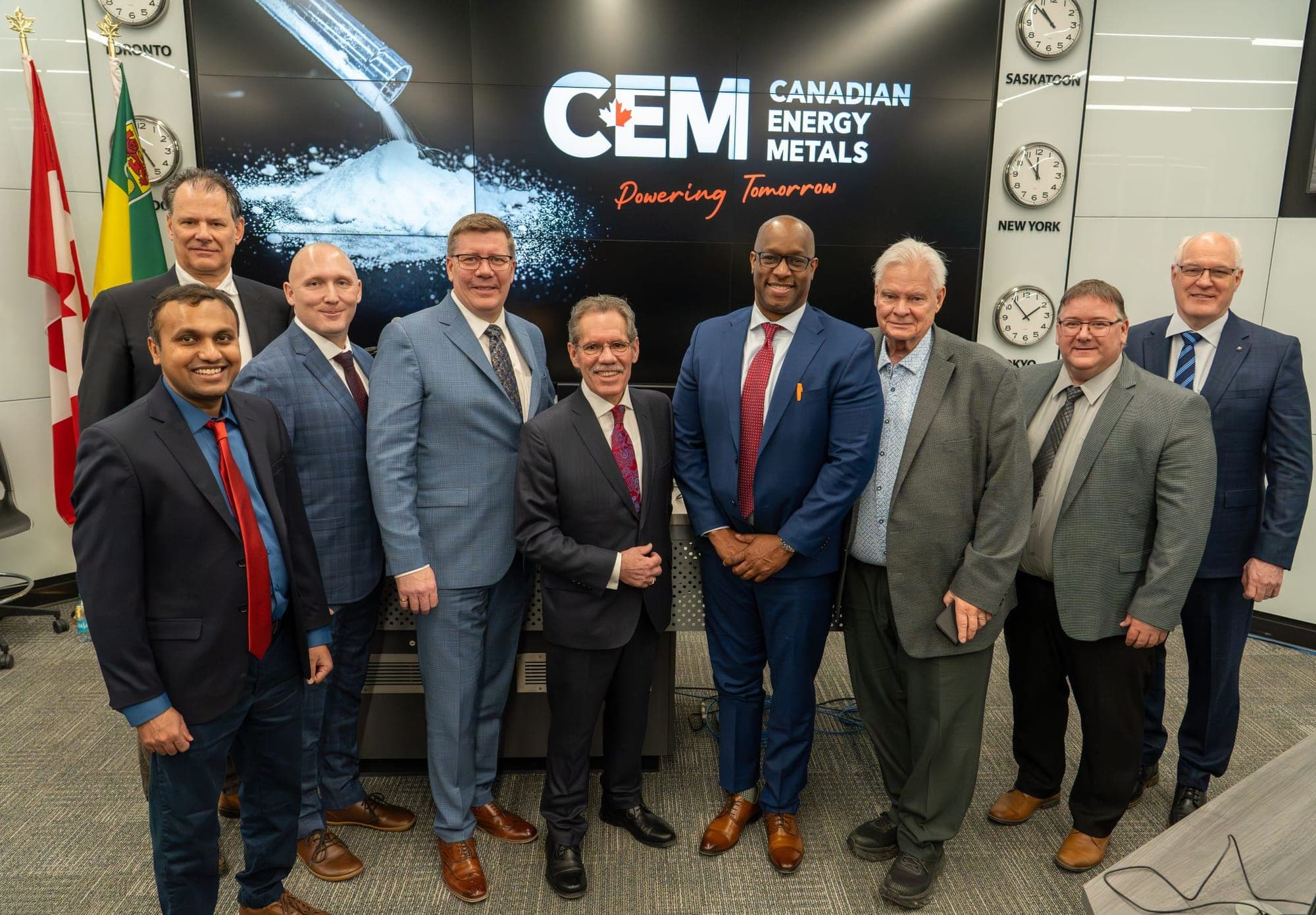Saskatchewan Premier Scott Moe stands with executives in front of a sign for Canadian Energy Metals.