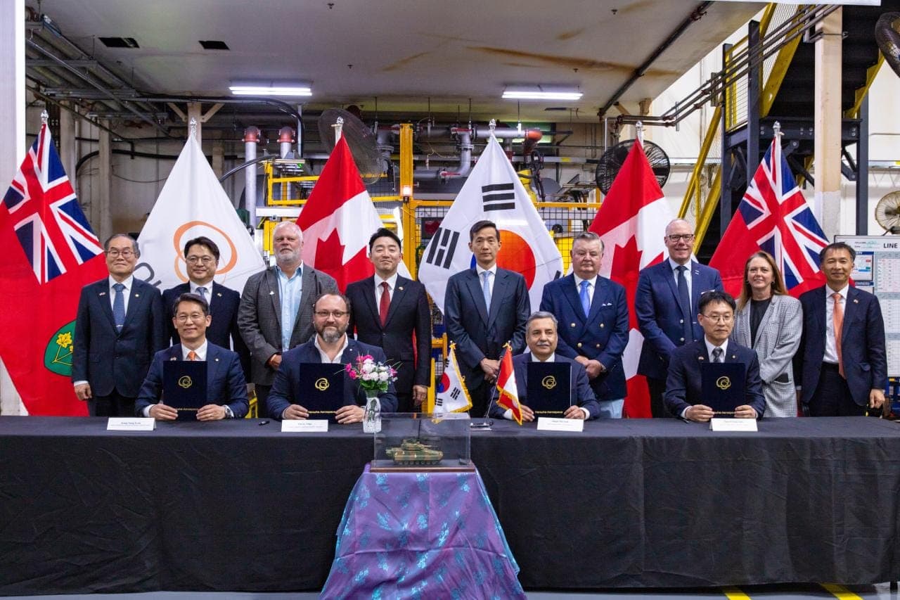 Executives from Hanwha Canada, the Automotive Parts Manufacturers' Association and Algoma Steel sign memoranda on June 1.