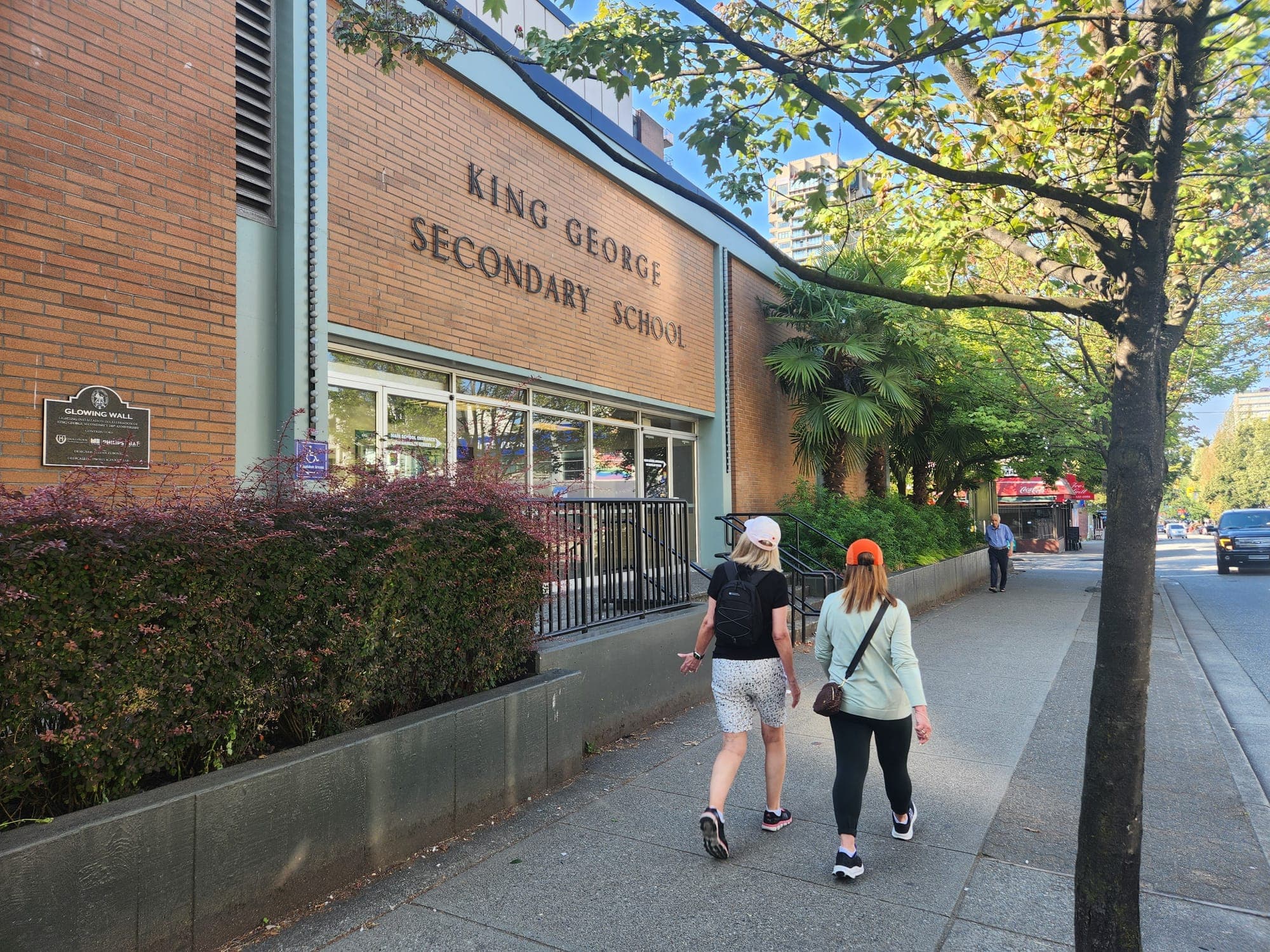 Pedestrians walk by a public high school in Vancouver's West End.
