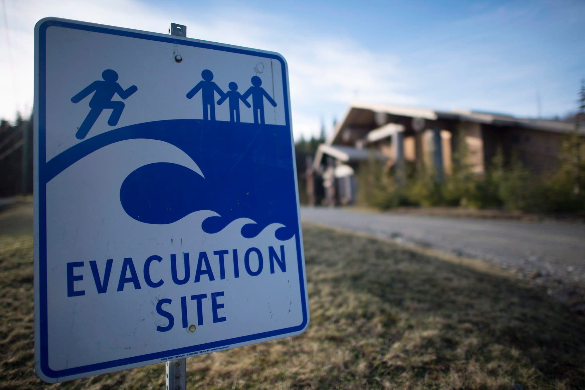 A tsunami evacuation site sign is shown on high ground near the House of Huuayaht in the village of Anacla in Pachena Bay, B.C