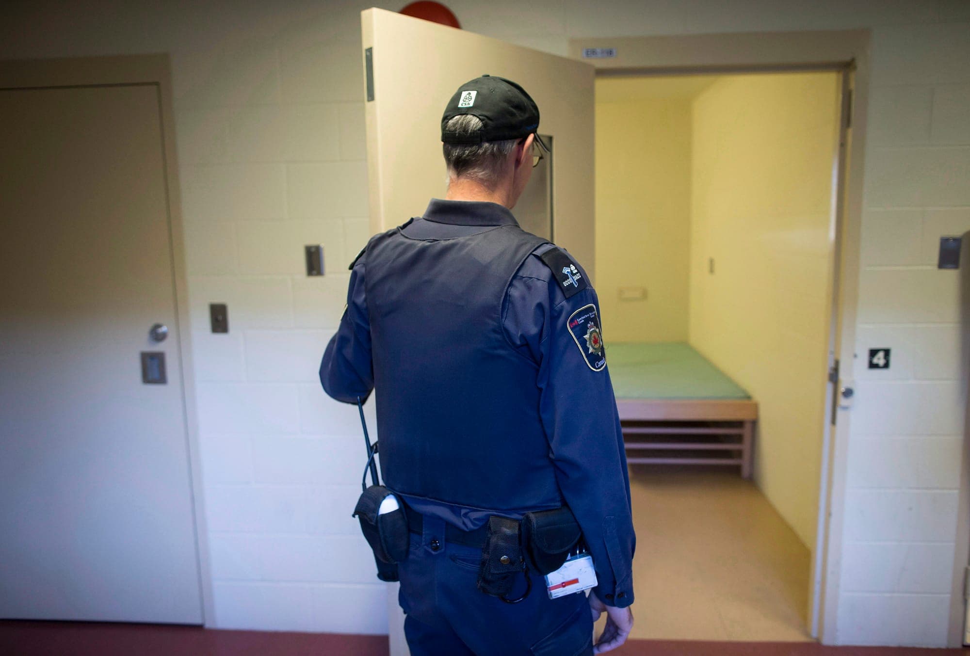 A corrections officer opens the door to a cell in the segregation unit at the Fraser Valley Institution for Women in Abbotsford, B.C. in 2017.