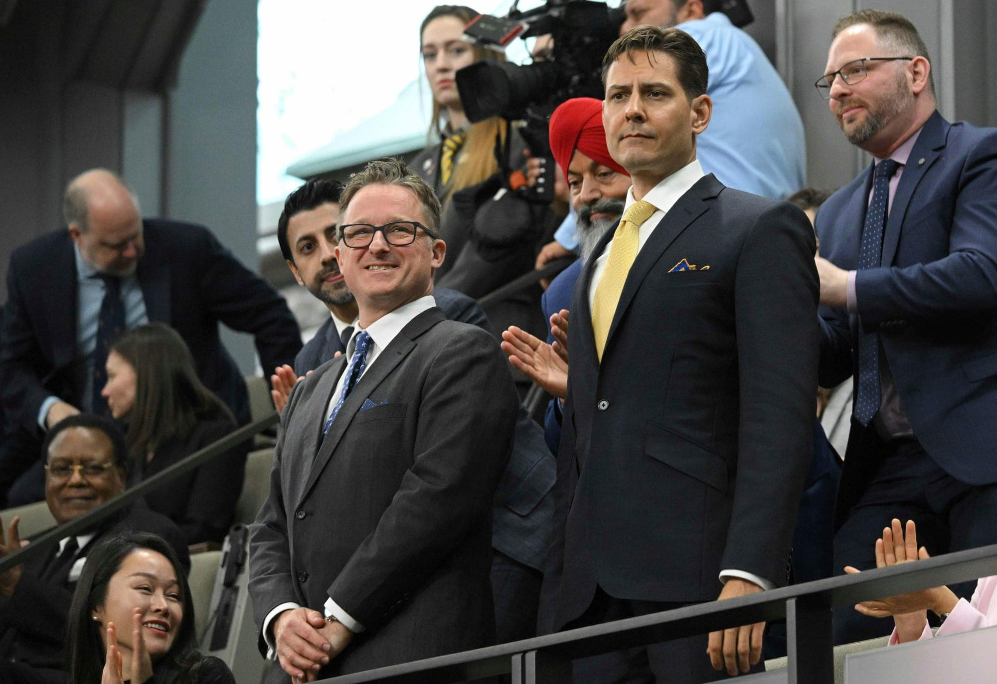 Canadians Michael Spavor and Michael Kovrig stand as they are recognized before former U.S. president Joe Biden speaks to the Canadian Parliament in Ottawa on Mach 24, 2023.