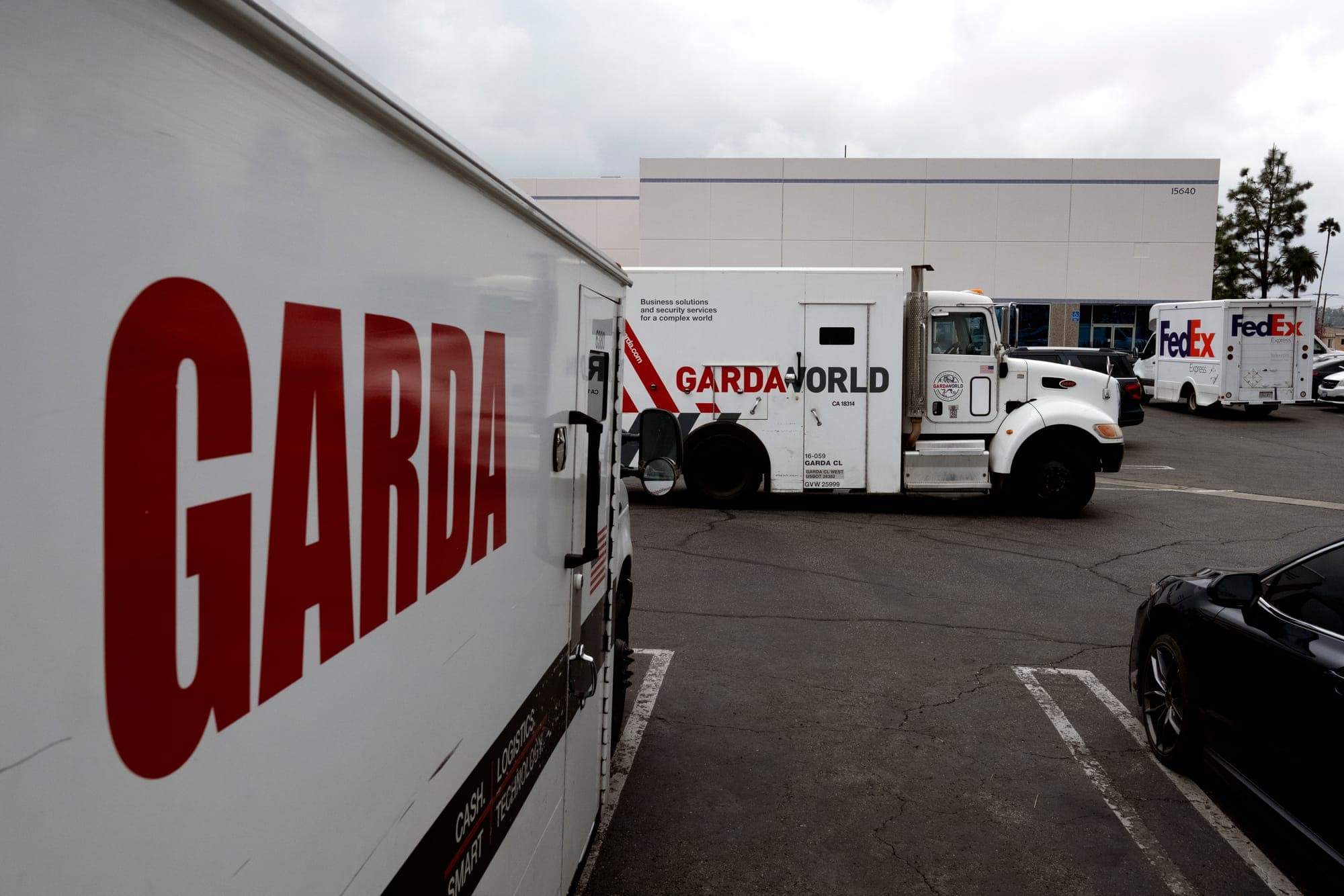 GardaWorld trucks are pictured in a parking lot. (AP Photo/Richard Vogel)