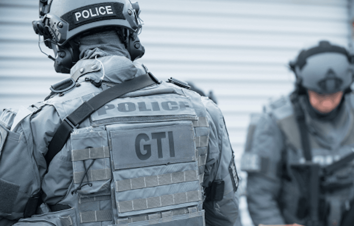 Two members of Montreal police's tactical team are pictured wearing body armour.