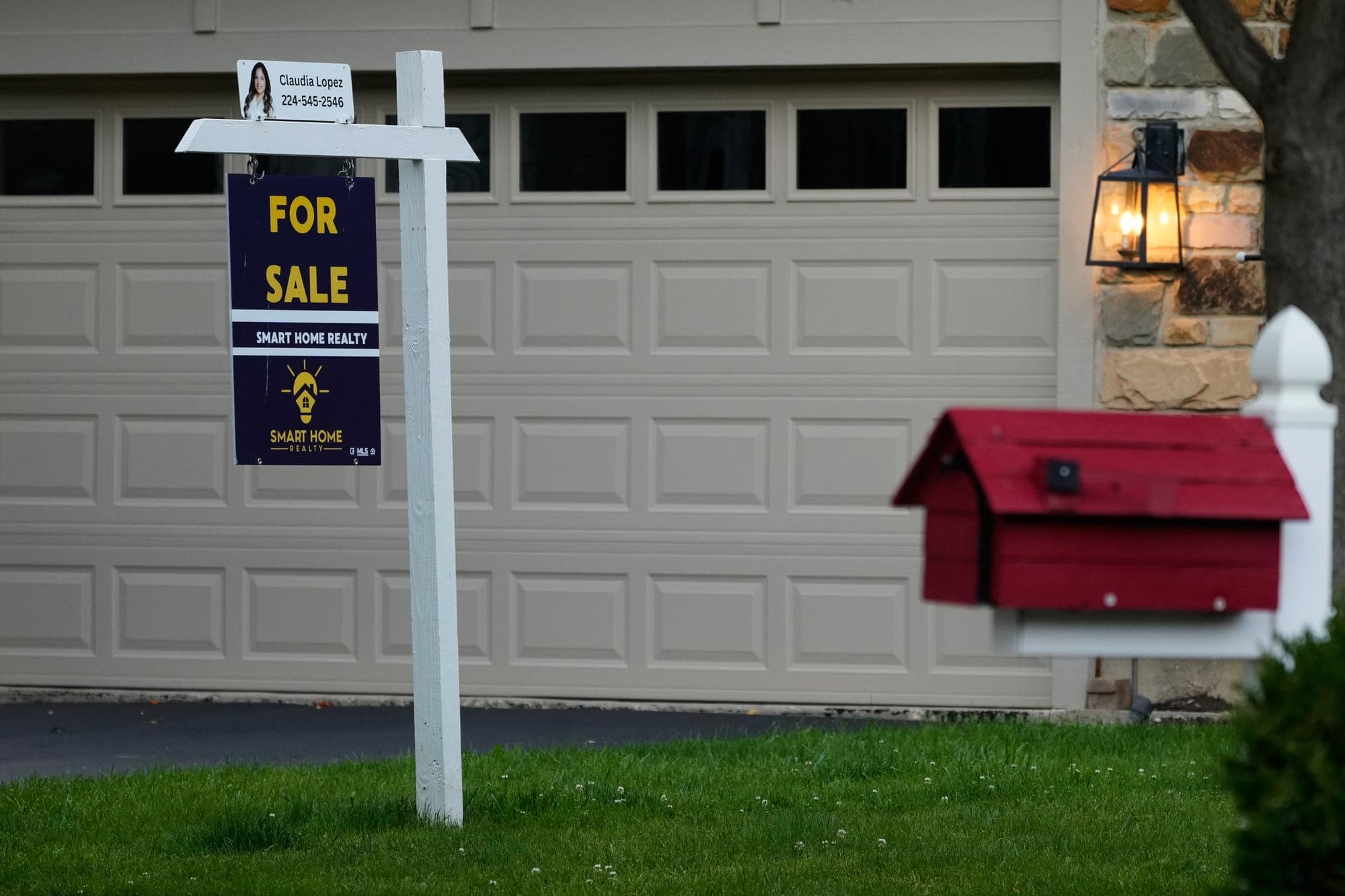 A home sale sign is seen outside of a home in Buffalo Grove, Ill. (AP Photo/Nam Y. Huh)