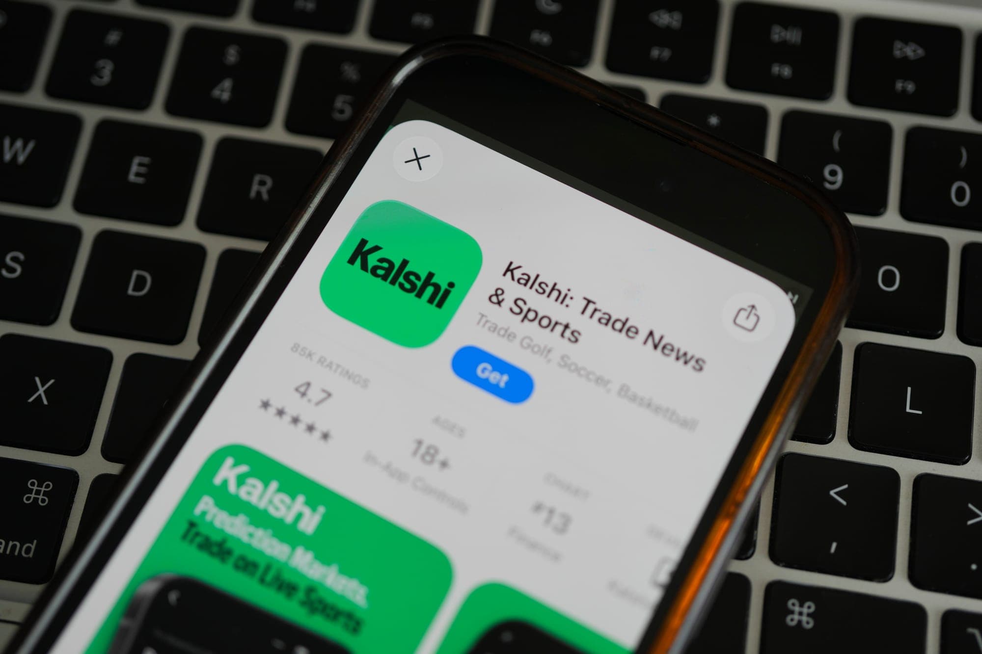 An ad for the prediction market app Kalshi is displayed on a mobile phone.