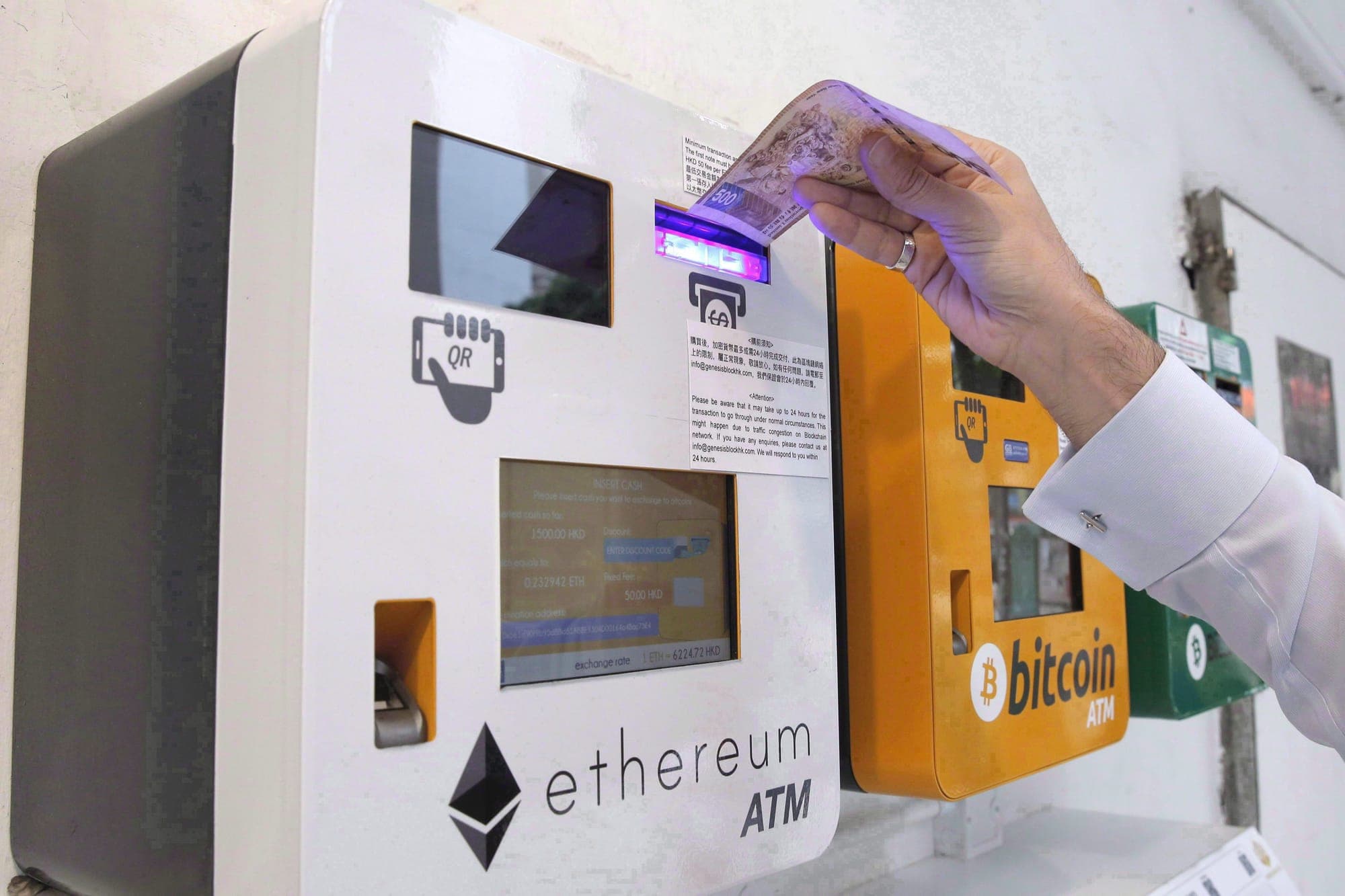 A man uses the Ethereum ATM, beside a Bitcoin ATM, in Hong Kong on May 11, 2018.